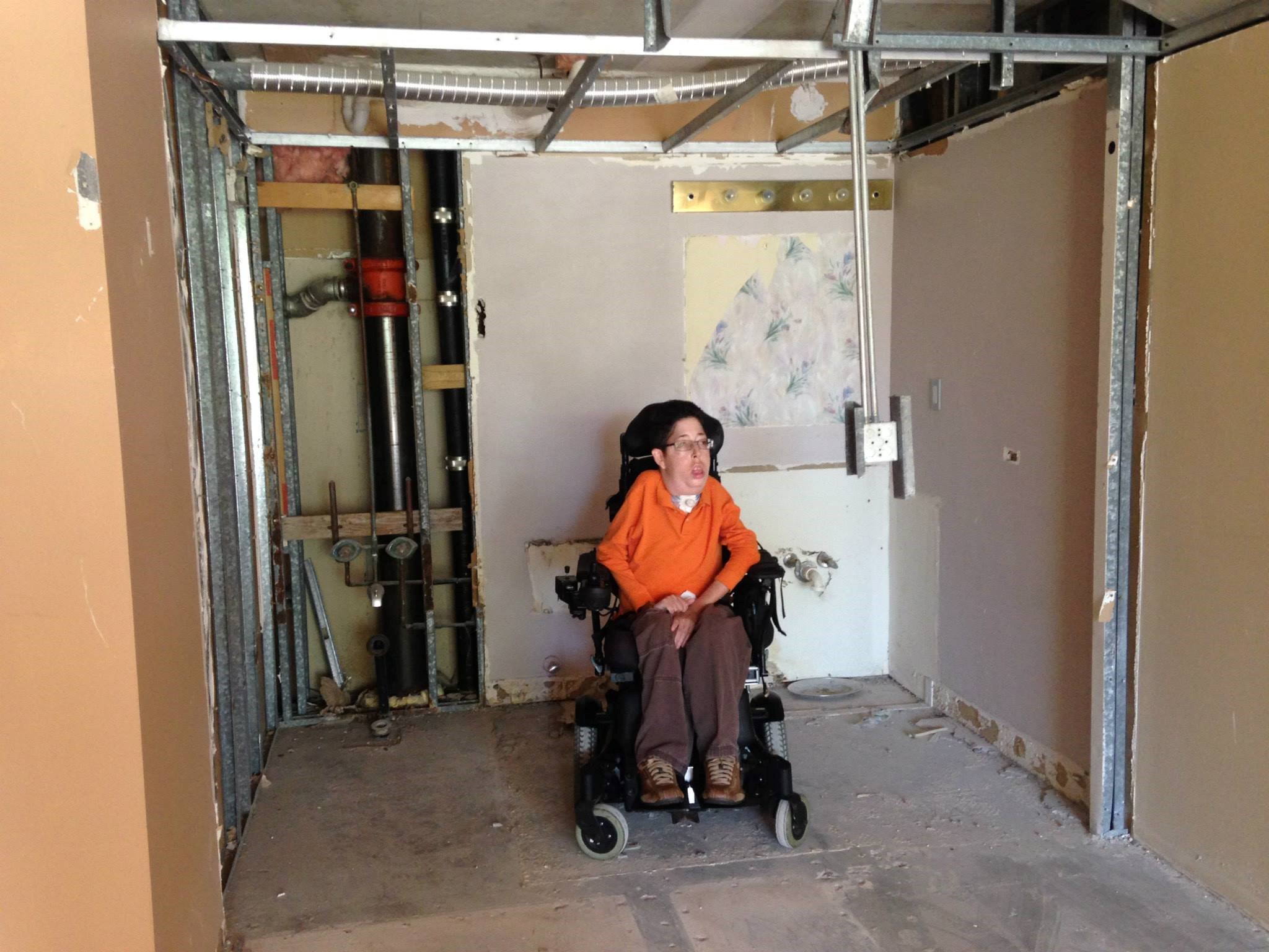 picture of Zachary Trautenberg in a motorized wheelchair in a home under constrution 