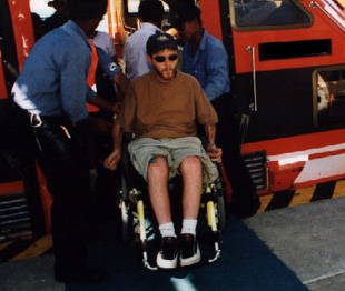 person in a wheelchair not being restricted by disability, on a cruise ship 