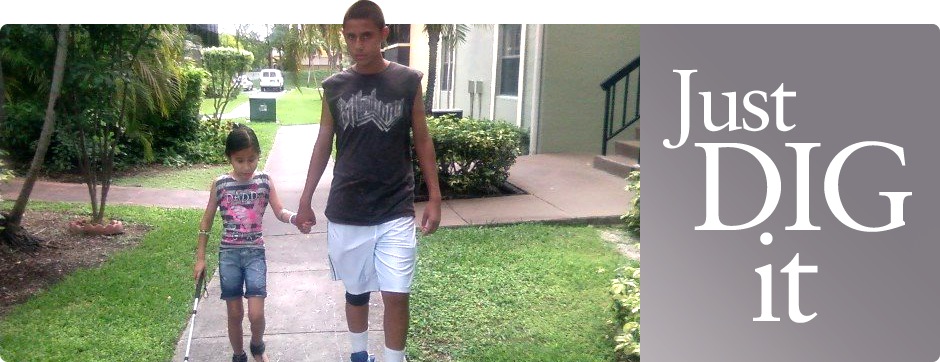 Photo of teenage boy and young girl walking down a sidewalk