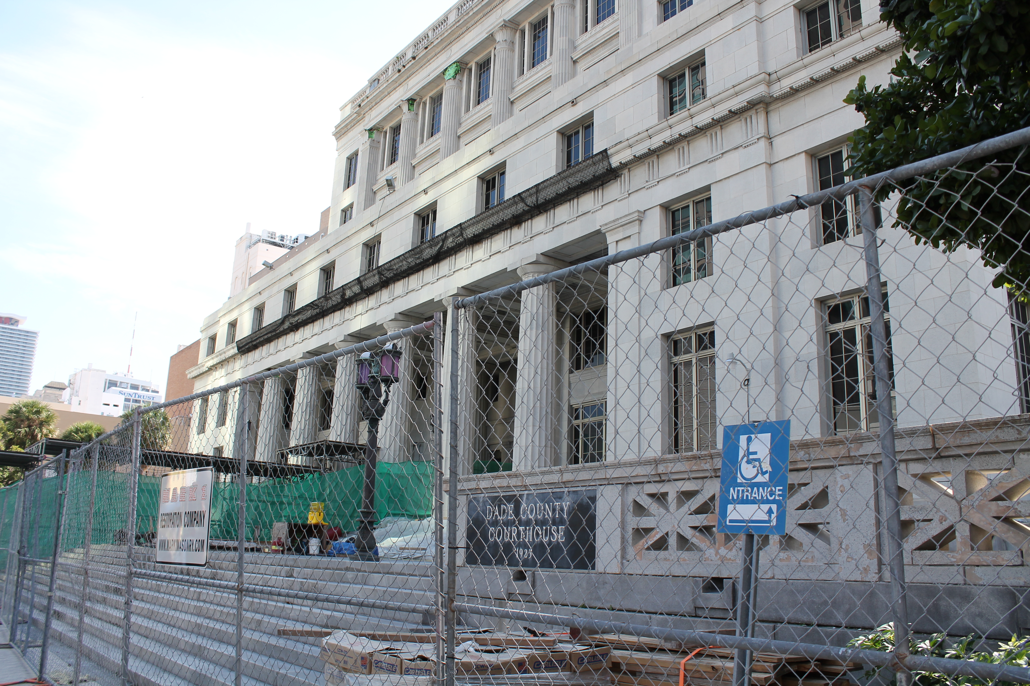picture of the dade county courthouse with a fence for construction