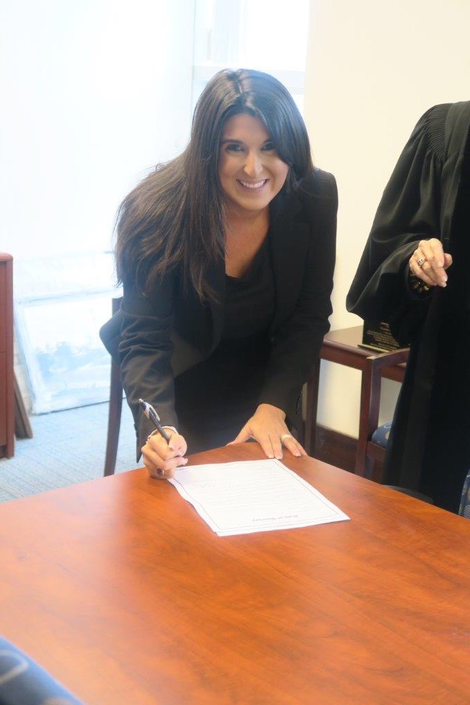 Lisa Goodman signing the official documents