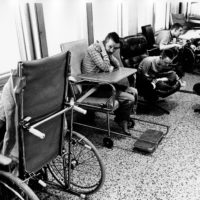 black and white pictures of persons in wheelchairs in an institutional setting