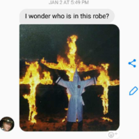 text of picture of man in white KKK robes infront of three burning crosses, with "I wonder who is in this robe? in a text above the picture