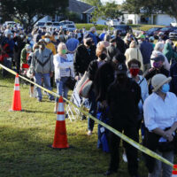 People waiting on a long line to get a vaccine