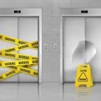 elevator doors with yellow warning tape across the doors elevator doors with yellow warning tape across the doors