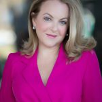 head shot of michelle wearing a bright pink top