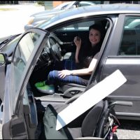 justine sitting in her car smiling and holding her car keys justine sitting in her car smiling and holding her car keys