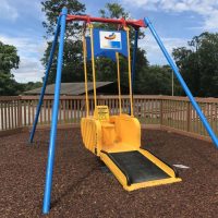 a wheelchair accessible swing at a playground