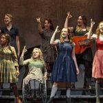 actors on a stage using sign language to perform