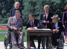 President Bush signing the ADA outstide at a table