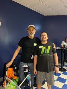 Theo and his son smiling at the bowling alley