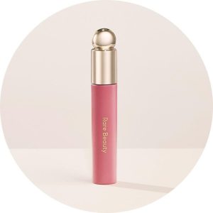bottle of rare beauty make up with a round top