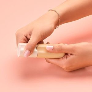 hands showing how to open the bottle of make up