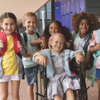 a group of elementary students with and without disabilities in a school hallway a group of elementary students with and without disabilities in a school hallway
